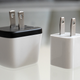 The Human Things Genki Covert Dock Mini sitting next to Apple's 5W iPhone charger.